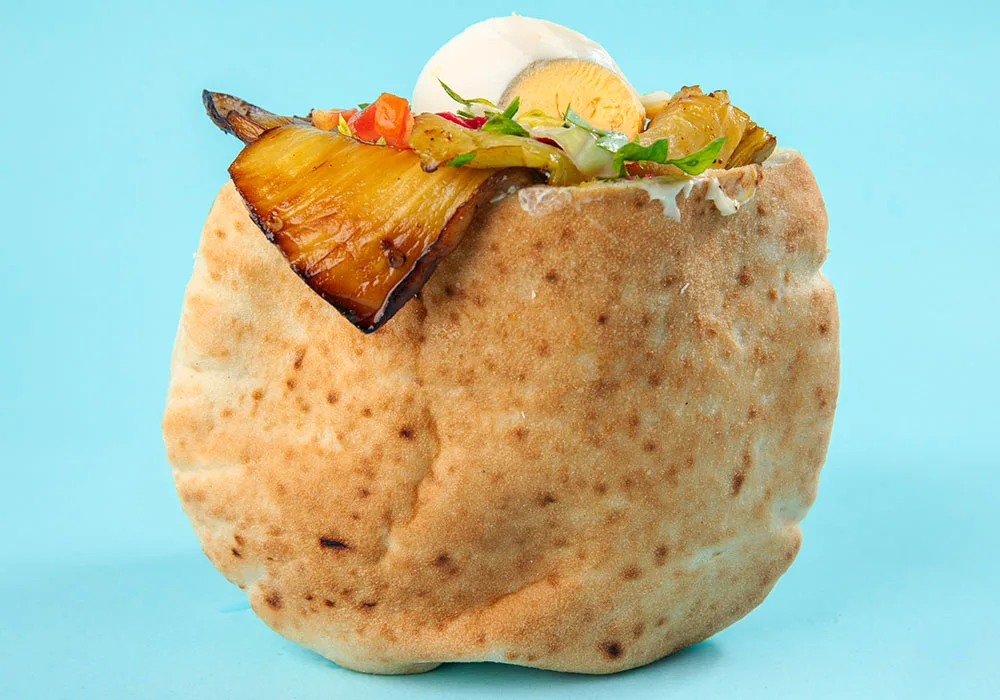 Pita filled with aubergine, egg, vegetables and sauces